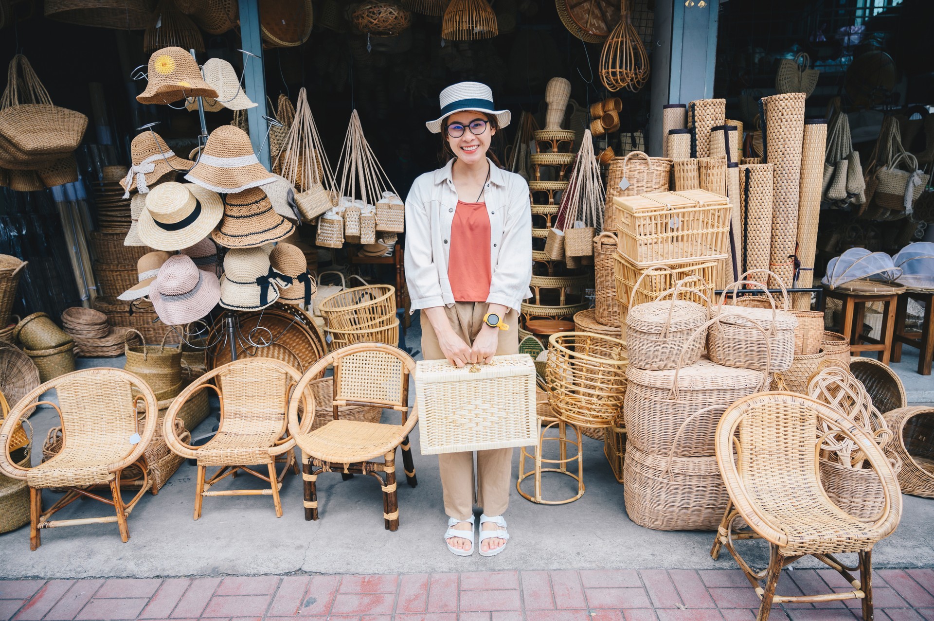 Happiness tourist woman visiting wicker shop located on Chang Moi Rd in the downtown of Chiang Mai province of Thailand.